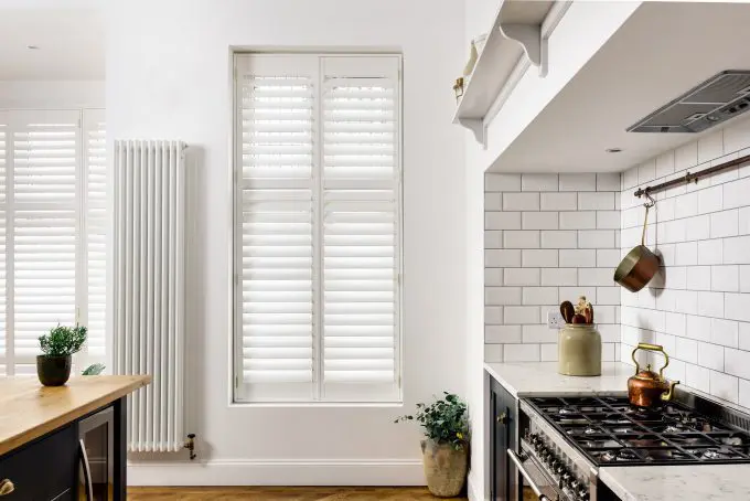 white full height shutters on kitchen windows