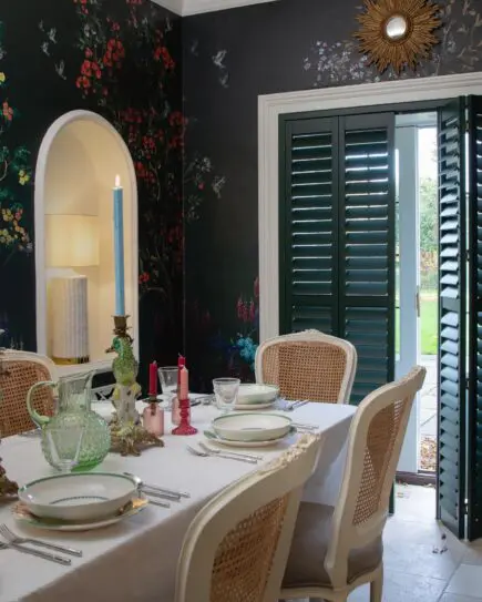 dark blue patio door shutters with dining table fully set in front of the door