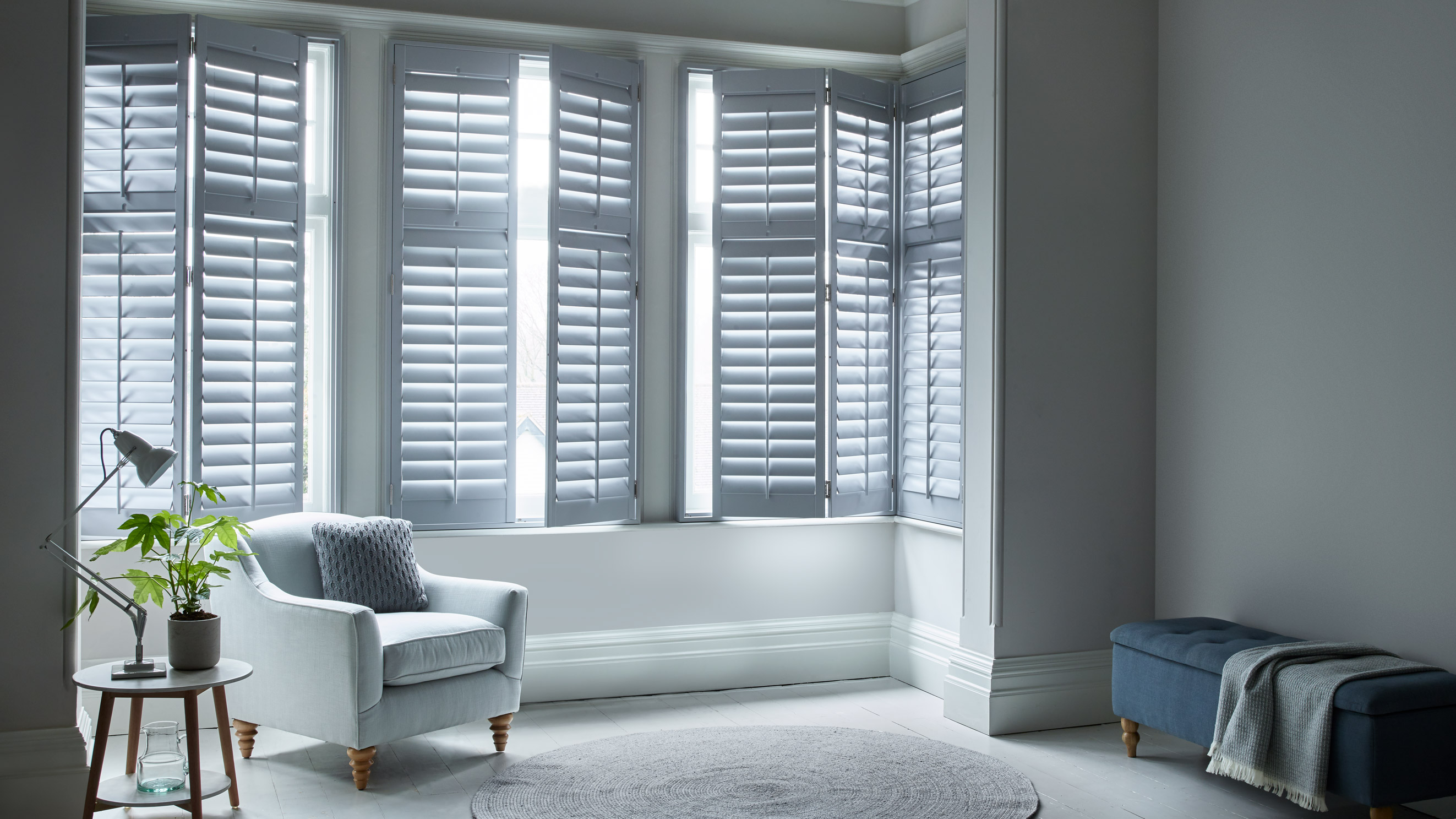 Custom grey full height shutters for the living room