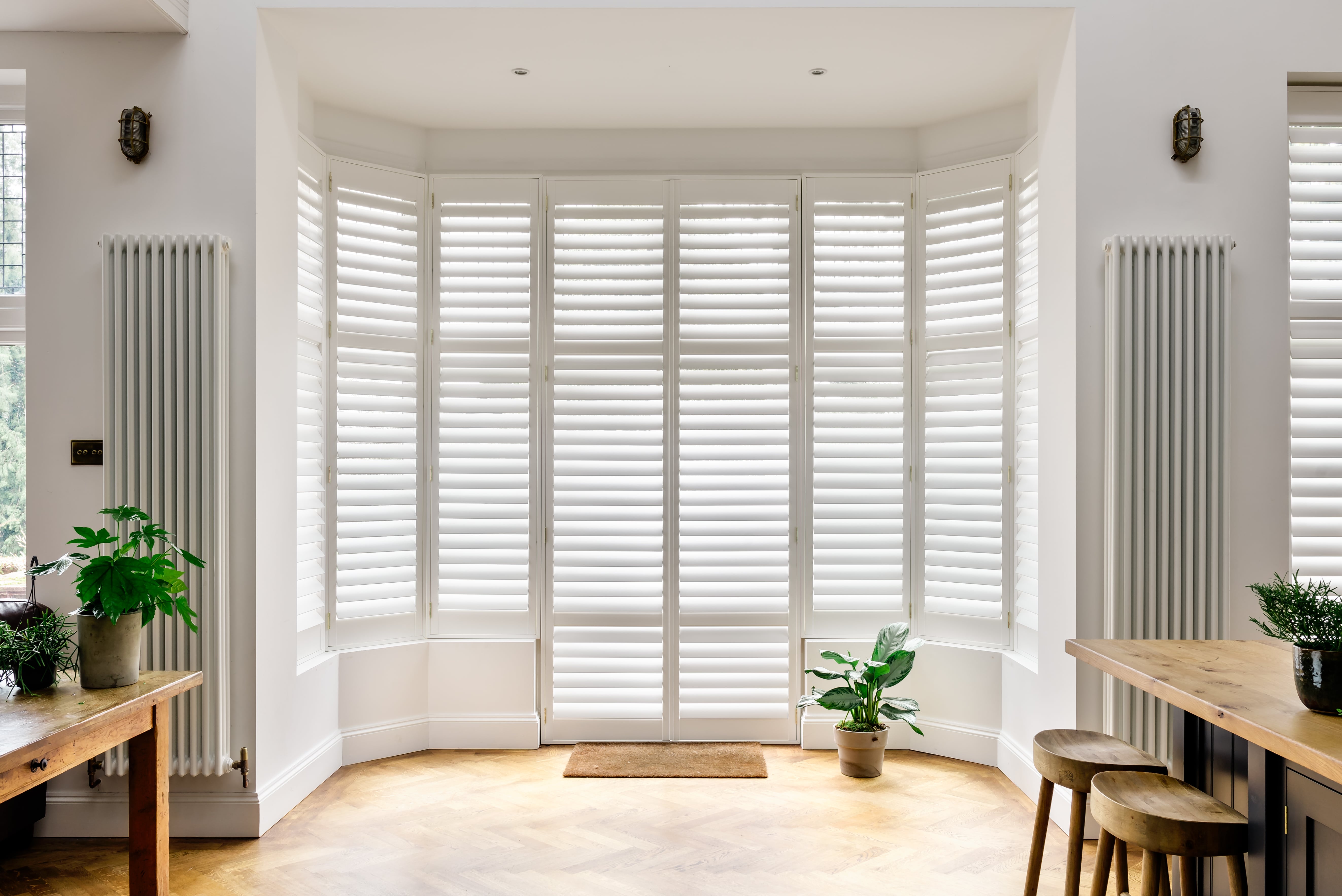 Full-height bay window shutters in white