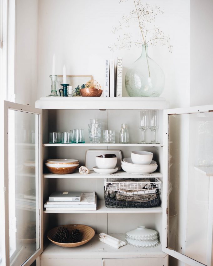 kitchen cabinet with glasses and bowls in there