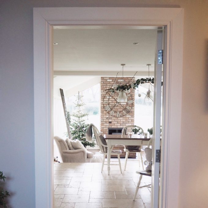 View of dining table and living room with Christmas tree