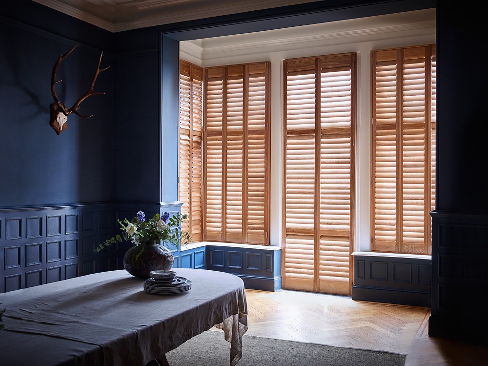 Box bay window shutters wood on dark blue walls