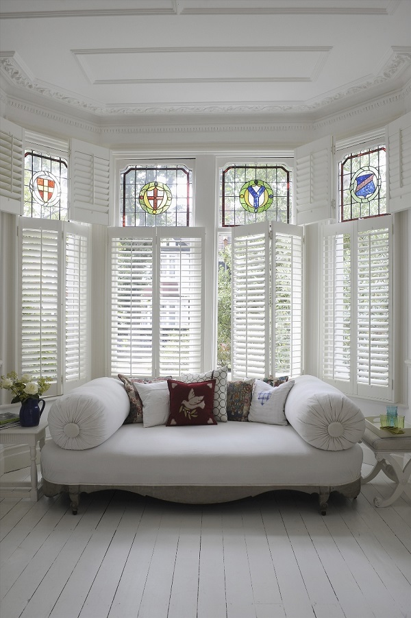 beautiful white bay window shutters