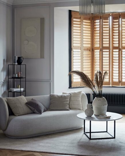 Full height wooden shutters in living room