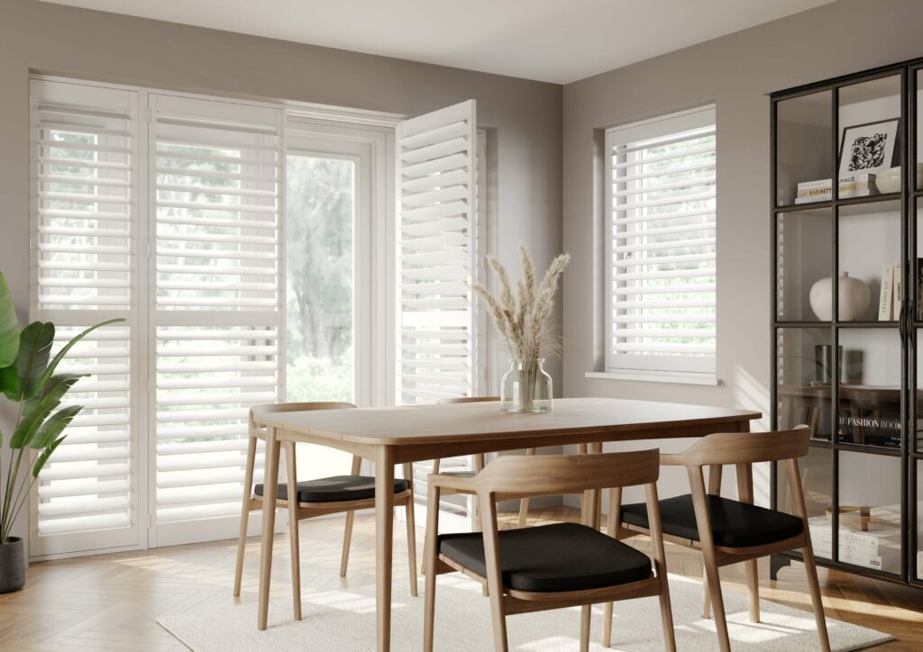 Full height window shutters next to dining table