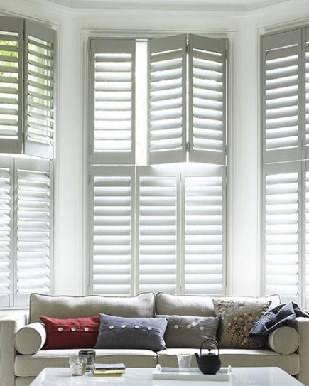 Bay window shutters in a living room