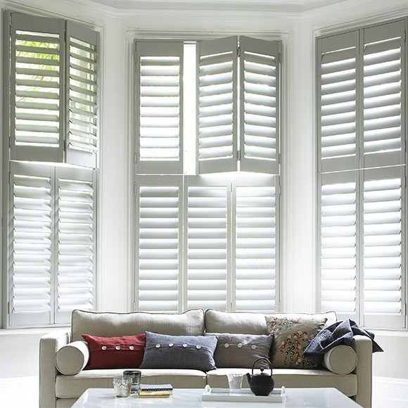 Bay window shutters in a living room