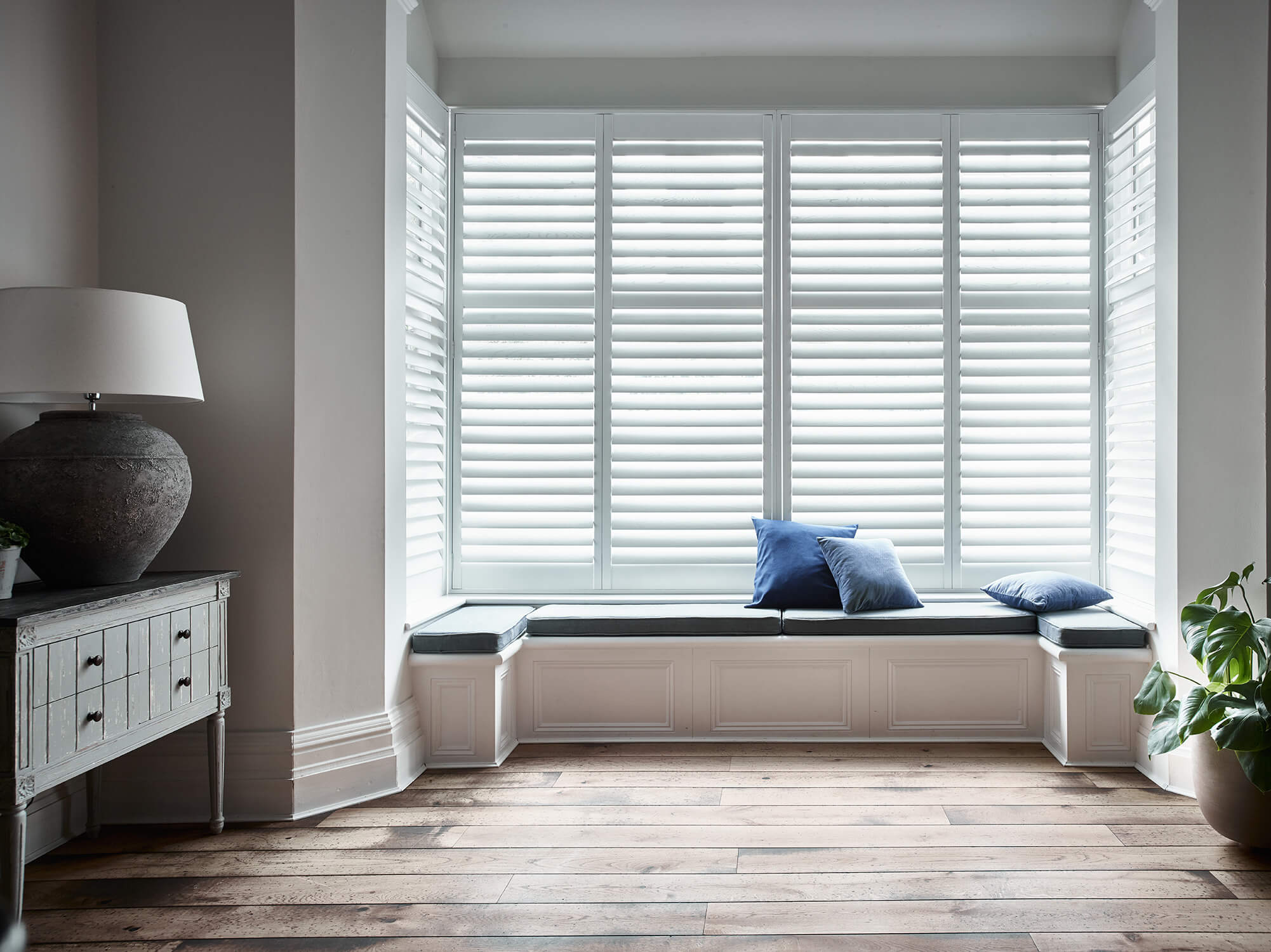 Bay window shutters behind seating bench