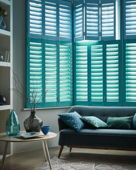 two tone blue tier on tier living room shutters