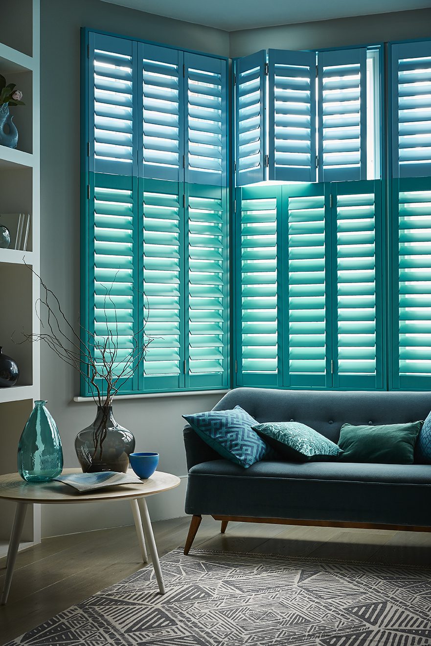 two tone blue tier on tier living room shutters