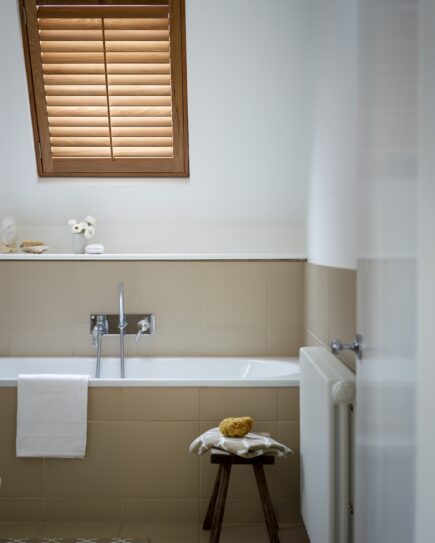 Brown Wooden velux window shutters in a bathroom