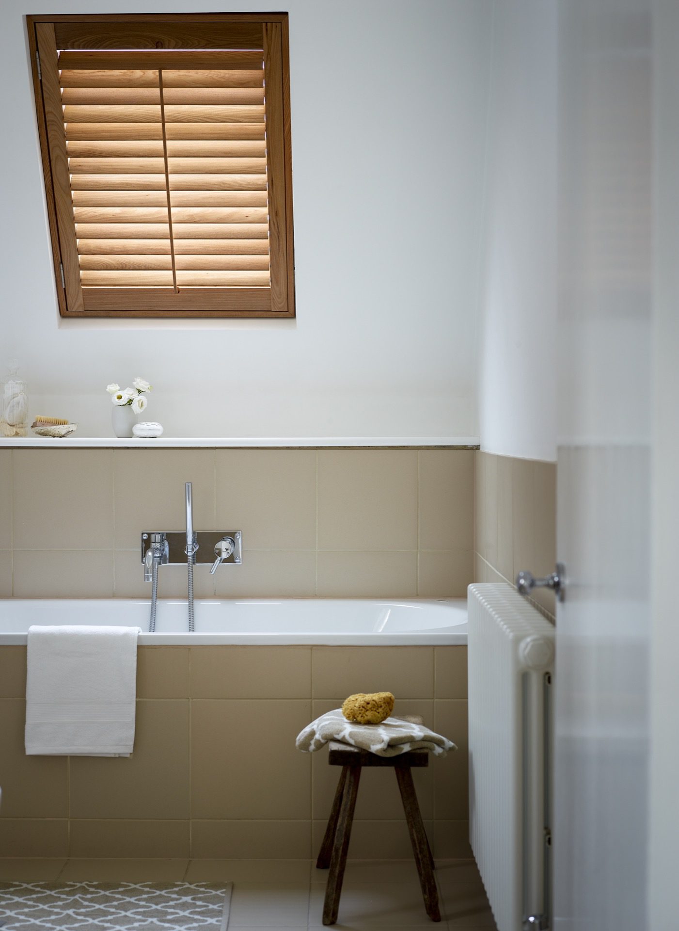 Brown Wooden velux window shutters in a bathroom