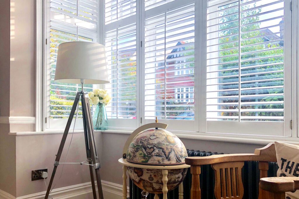 open-slatted white plantation shutters