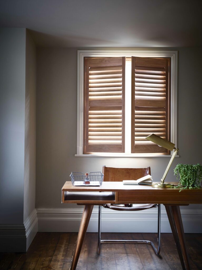 Brown mid rail shutters on office window 