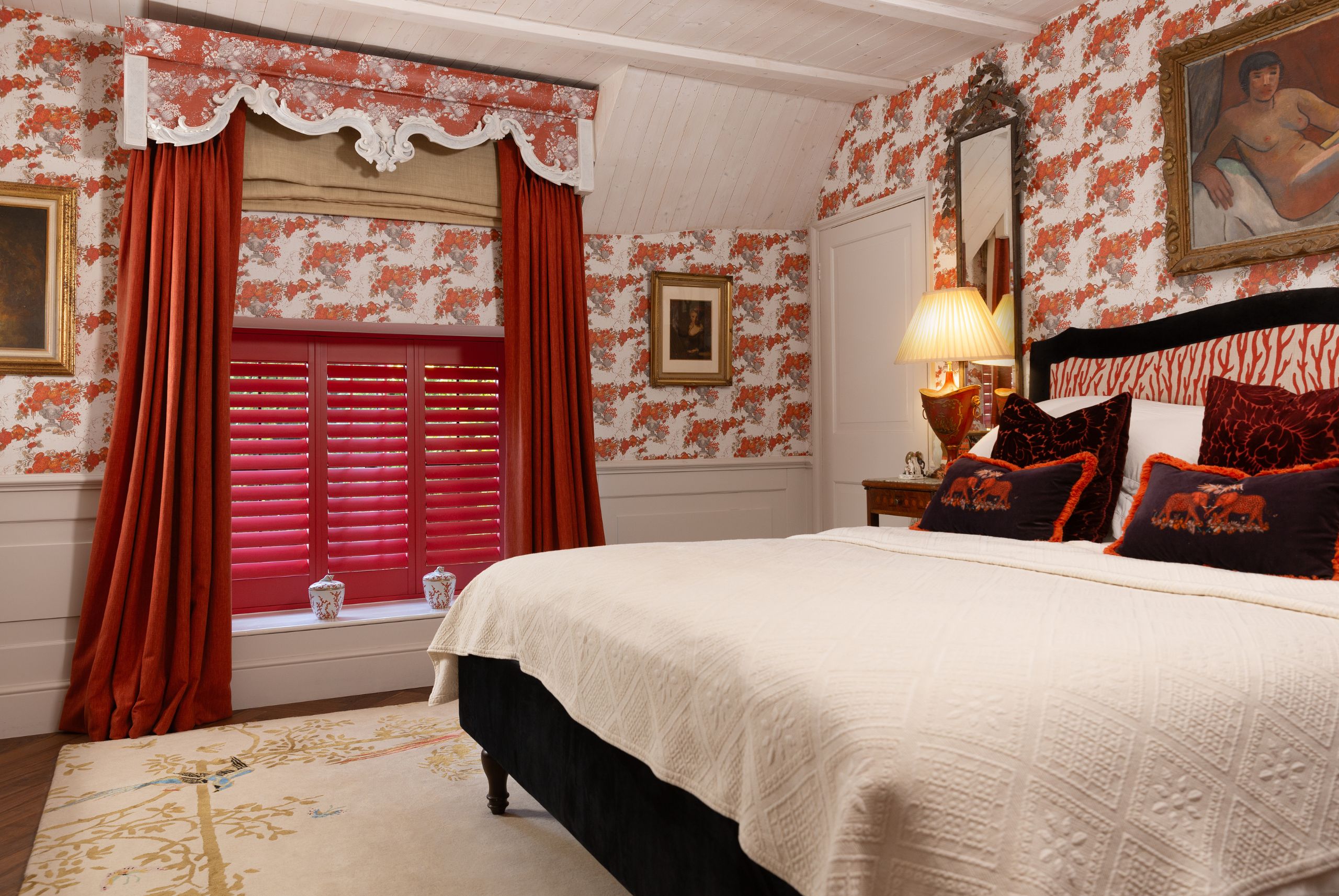 pink shutters in bedroom with striking wall paper